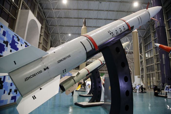 Iran missile displayed in a large indoor facility, highlighting Iran warns severe response after Trump threatens new strikes.
