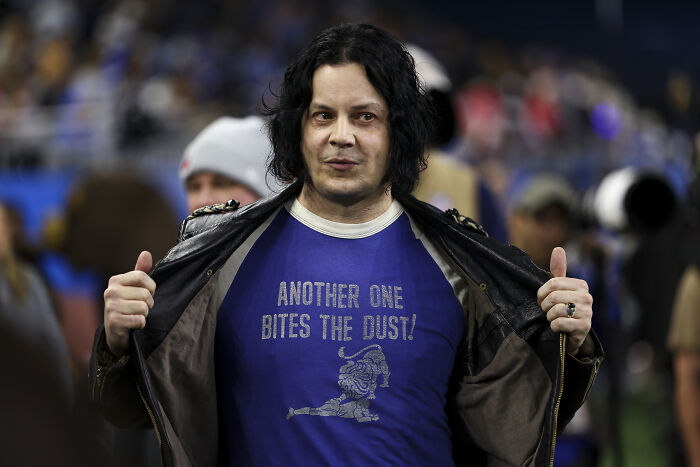 Jack White at an event wearing a blue shirt under a leather jacket, related to AI video controversy with lawmaker and Trump supporters.