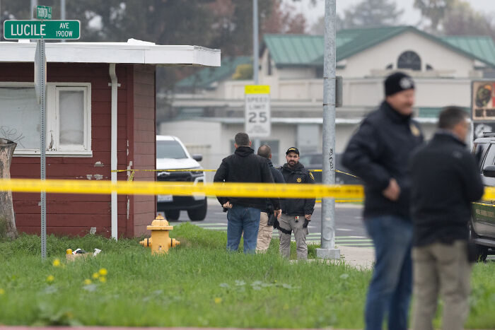 Police officers standing near a crime scene with yellow tape on Lucile Avenue during crimes that shocked the nation in 2025.