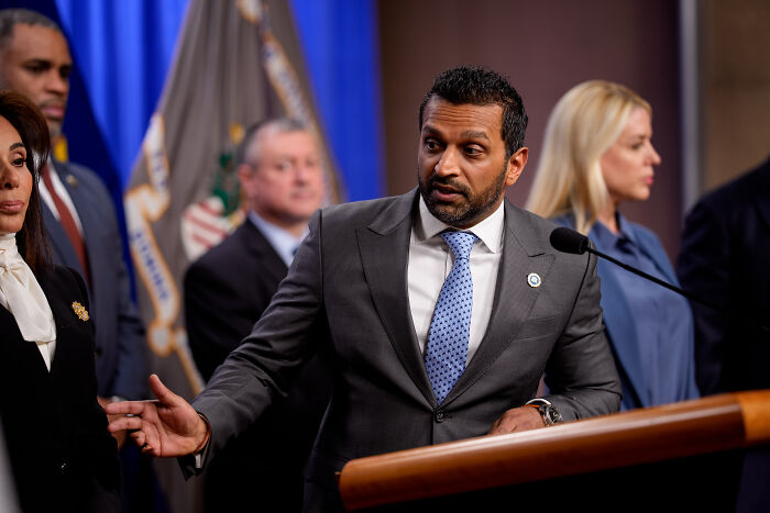 FBI chief speaking at a podium during a press conference about DC pipe b**b investigation and federal concerns.
