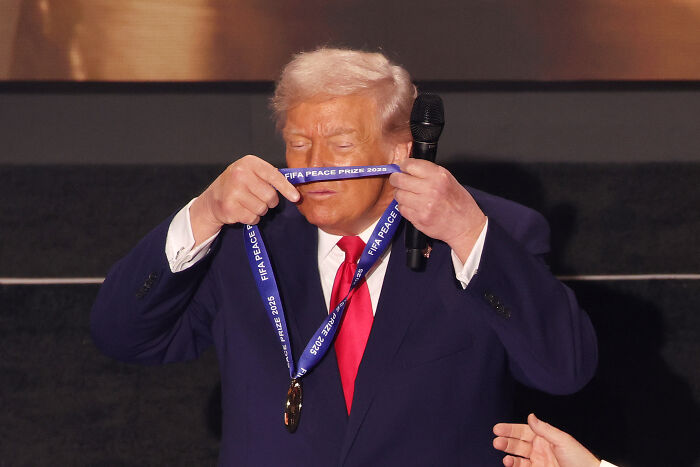 Donald Trump holding a FIFA Peace Prize participation medal, sparking memes about the award and his peace prize trophy.