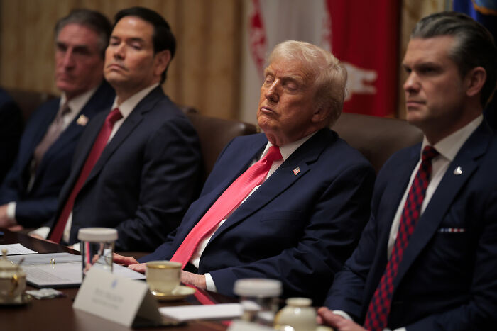 Donald Trump and cabinet members seated at a meeting table during a tense cabinet meeting moment that shocked the nation.