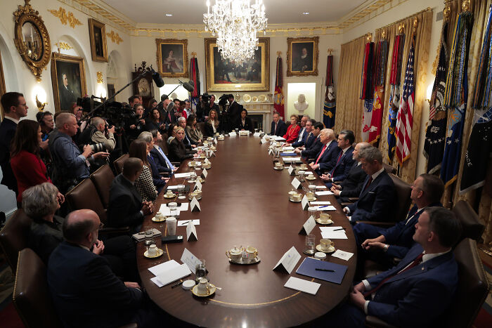 Trump&rsquo;s cabinet meeting in the White House with officials seated around a long table during a high-profile discussion.
