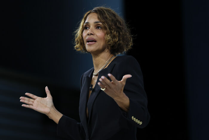 Halle Berry speaking at an event with expressive hand gestures amid Gavin Newsom&rsquo;s devaluing women discussion.