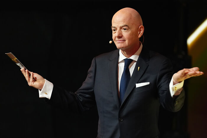 FIFA President Gianni Infantino in a dark suit speaking at an event amid ethics complaint over peace prize controversy.