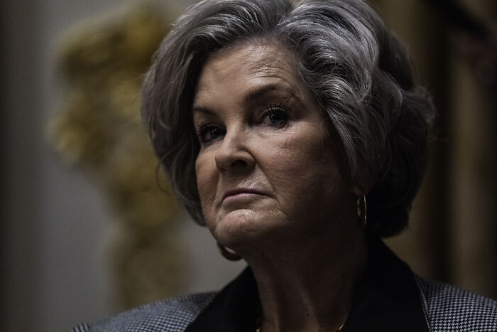 Woman with gray hair and serious expression, representing Trump&rsquo;s chief of staff in a formal indoor setting.