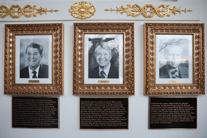 Portraits of Reagan, Carter, and Ford with plaques beneath, White House adds plaques under Biden and Obama portraits.