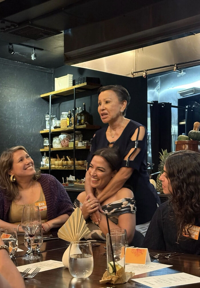 Women enjoying fine dining experience at a restaurant, highlighting luxury hotels and Puerto Rico venue spending by AOC.