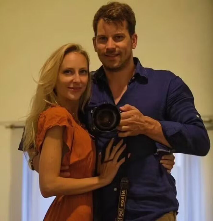 Man holding camera taking selfie with woman in orange dress relating to husband charged in disturbing case keywords