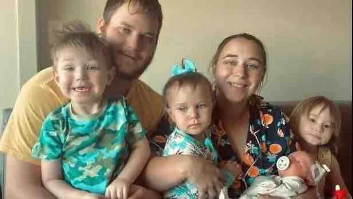 Family portrait with parents and children, related to house fire tragedy involving 3 children passing away and injuries.
