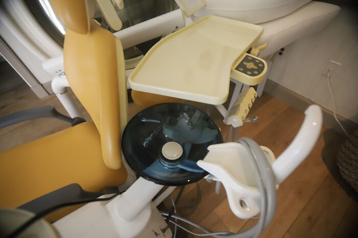 Dental chair and equipment in a small clinic room unrelated to Democrats Epstein bank records or island photos news topic.