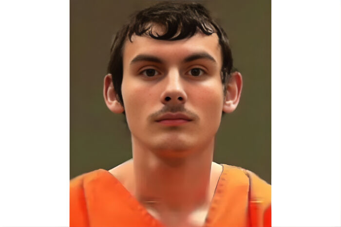 Teen arrested after attack on parents, mother fatally injured, while siblings were inside the home, wearing orange jail uniform.