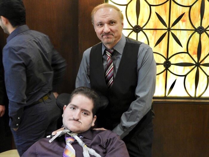 Father and disabled son in formal attire at an event, highlighting ICE blocking father from attending son's funeral.