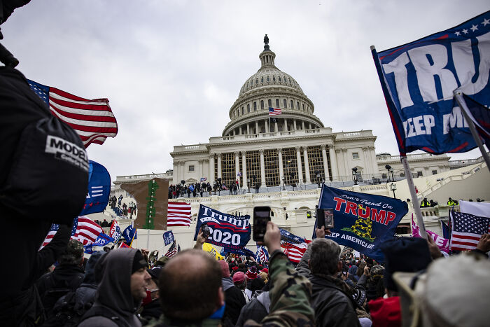 Crowd waving Trump flags at the U.S. Capitol, Trump panics theme amid protests