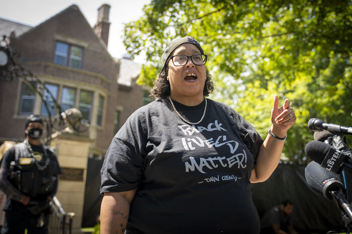 Protester speaking outside Minnesota church, amid White House acknowledgment of sharing modified image controversy.