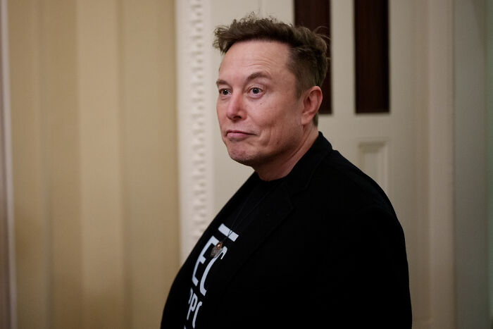 Elon Musk in a black jacket indoors, related to Trump-Musk bromance and Tesla CEO dinner photo in 2026.