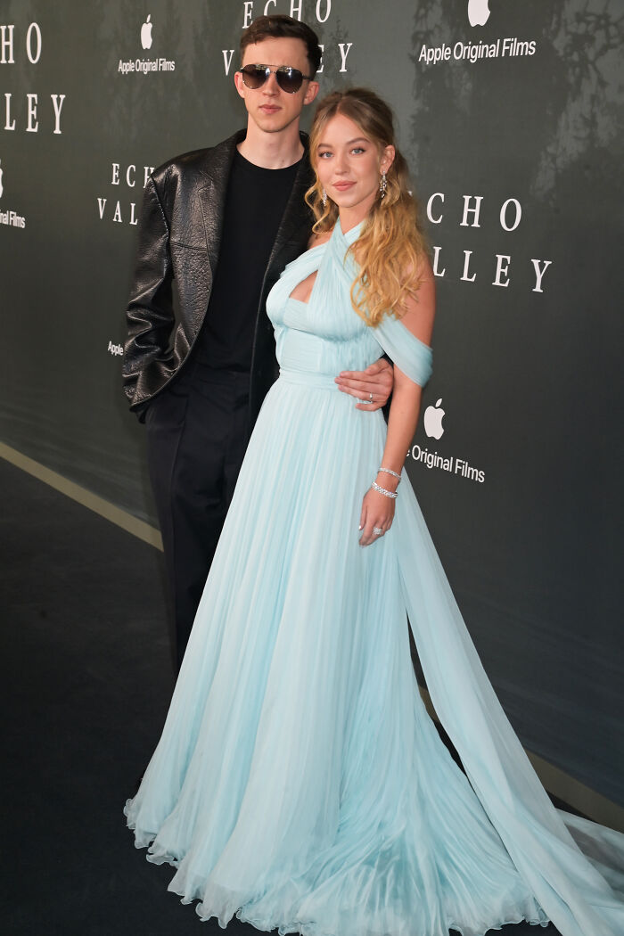 Sydney Sweeney in a flowing blue gown with brother at Echo Valley premiere amid rumored MAGA family ties controversy.