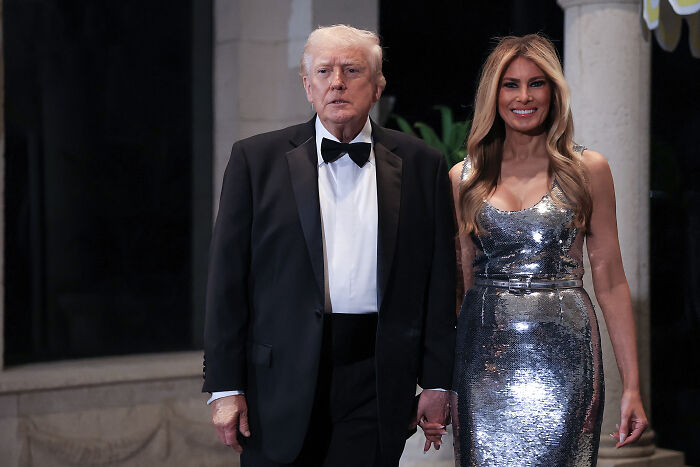 Donald Trump and Melania Trump dressed formally at a lavish event, highlighting NYE celebration and health cost concerns.