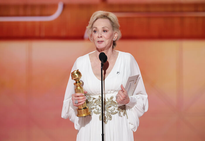Hollywood A-lister holding a Golden Globe onstage, using the platform to take a stand against ICE policies.