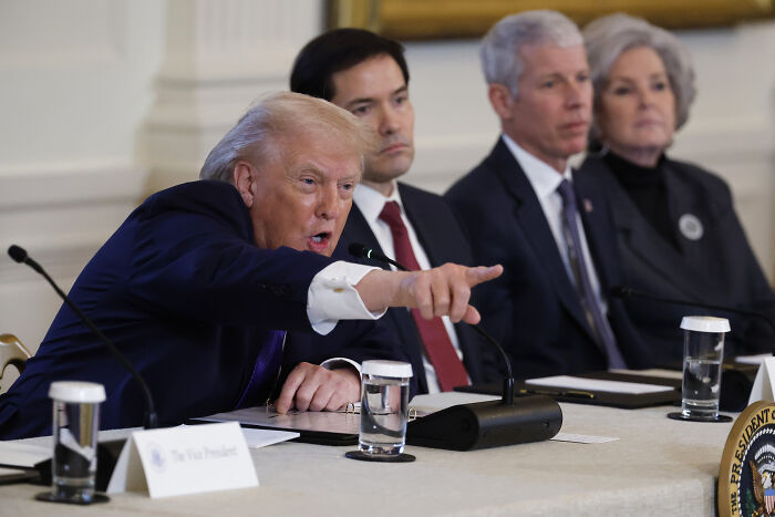 Donald Trump pointing during a meeting with officials discussing Greenland and its psychological importance to him.