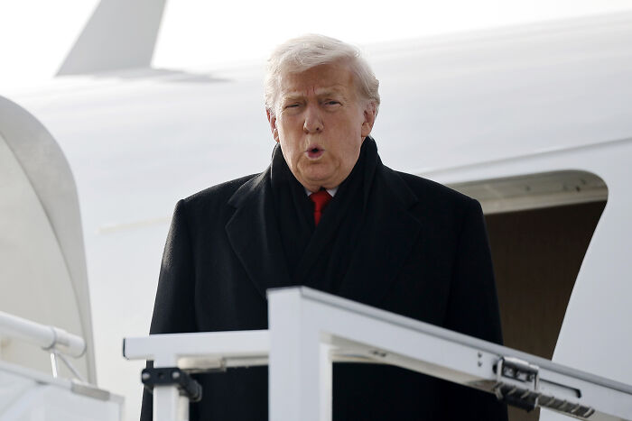 Former President Trump in a black coat descending airplane stairs, during his Davos speech with many cringe moments.