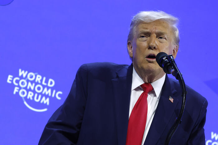Donald Trump speaking at the World Economic Forum in Davos, addressing geographic issues during his speech.