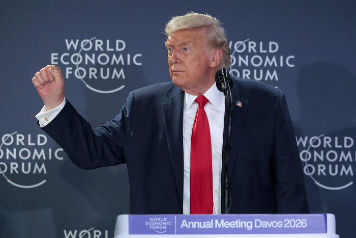 Donald Trump at the World Economic Forum podium during his Davos speech with several cringe moments highlighted.
