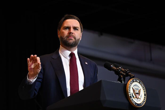 JD Vance speaking at a podium with Vice President seal, responding to ICE detaining a 5-year-old boy in Minneapolis.