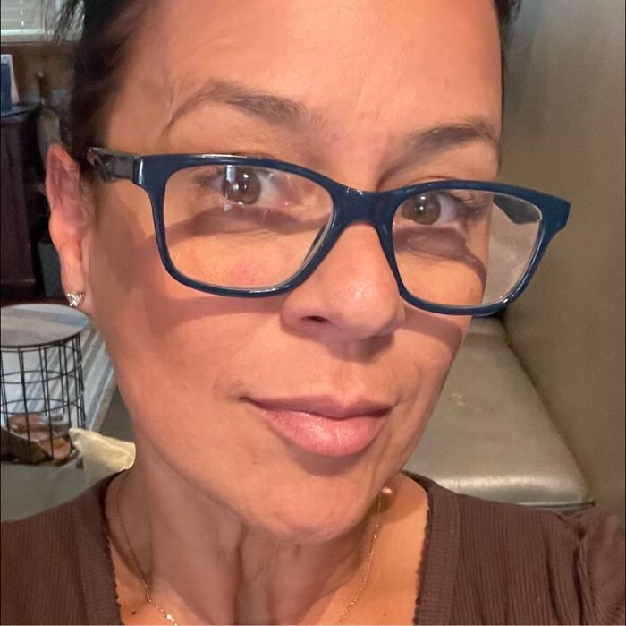 Woman wearing glasses taking a close-up selfie related to Miami Beach mayor free-speech police questioning controversy.