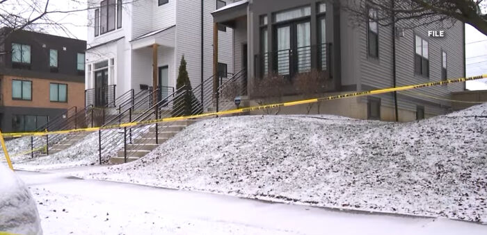 Townhouse with yellow police tape in snow, crime scene linked to slain Ohio couple surveillance video