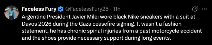 Argentine President Javier Milei wearing black Nike sneakers with a suit at Davos, standing out during a formal event.