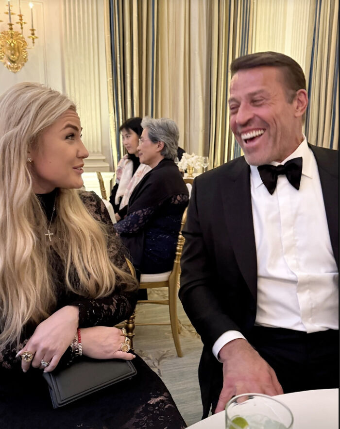 Woman with long blonde hair and man in tuxedo laughing together at a formal event with Melania Trump documentary screening theme.