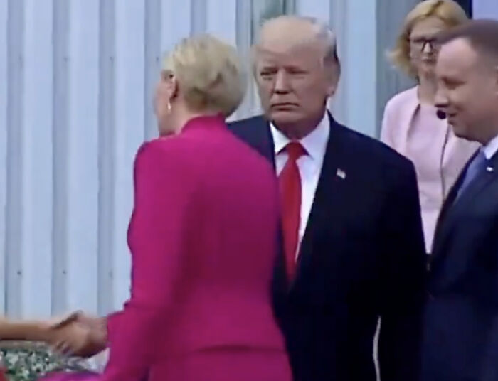 Donald Trump looking embarrassed as woman snubs greeting with a "perfect" reaction during a formal event.