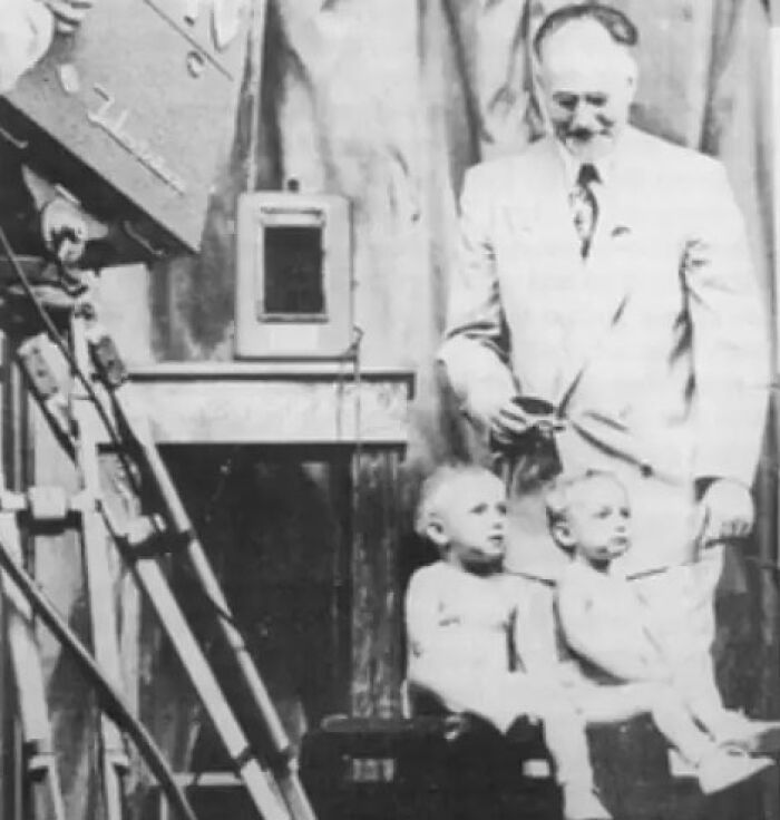 Vintage black and white photo of a man with two children, linked to a century-old radical plan and Elon Musk&rsquo;s grandpa.