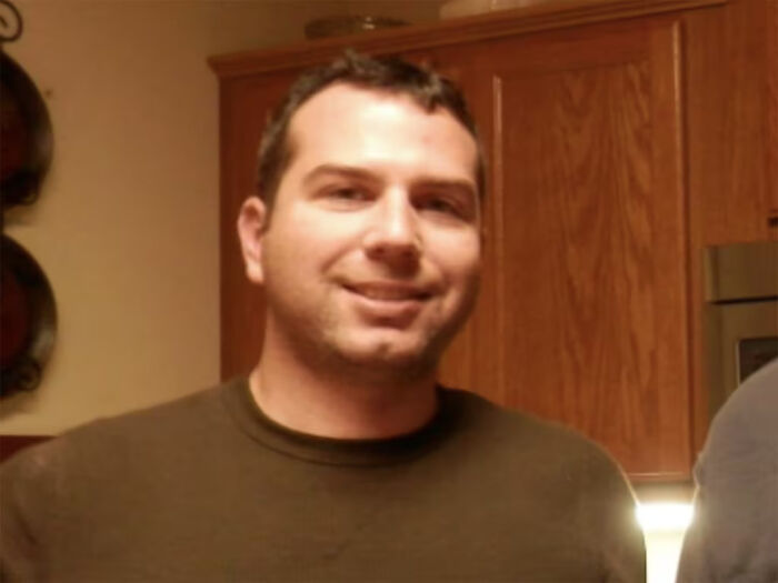 ICE agent in a casual setting with a slight smile, involved in shooting Renee Nicole Good and strange cover story.