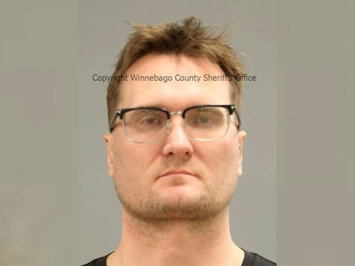Mugshot of Michael McKee with glasses, facing forward, related to arrest over attacks on his ex and dentist husband.