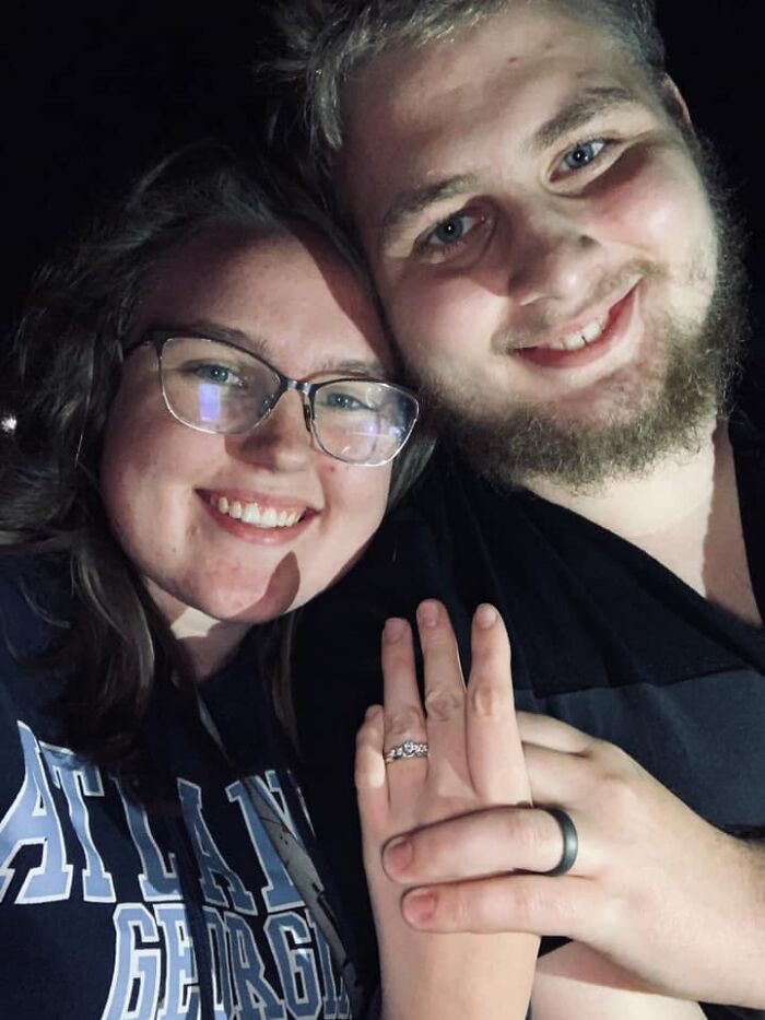 Young couple smiling together at night, representing Minnesota gubernatorial candidate affected by knife attack tragedy.