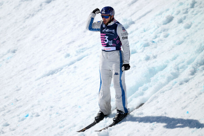 U.S. Olympic athlete in ski gear celebrates on snow, amid Trump attacks on athlete&rsquo;s mixed emotions.