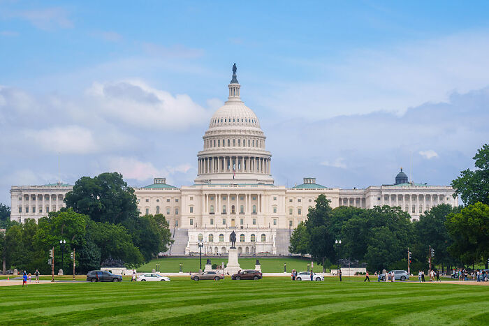 US Capitol building with visitors on lawn, symbolizing House bipartisan vote to cancel Trump&rsquo;s Canada tariffs.