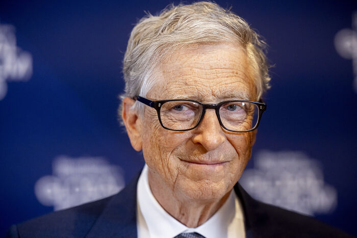 Bill Gates wearing glasses and a suit at an event, linked to more disturbing details after Epstein allegations.