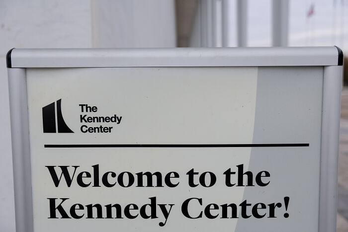 Sign at the Kennedy Center entrance welcoming visitors, related to Trump&rsquo;s statement about Kennedy Center repairs and closure.