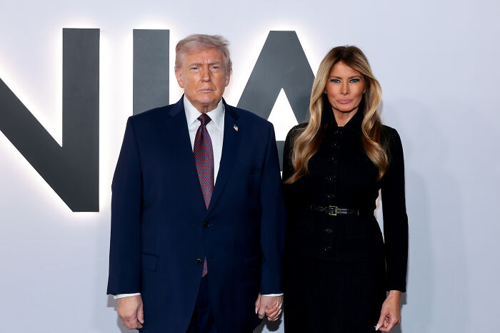 Donald Trump and Melania Trump posing together at an event promoting Melania Trump documentary box office success.