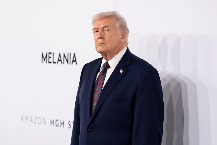 Donald Trump in a dark suit and tie at an event, related to Kennedy Center closure and renovation announcement.