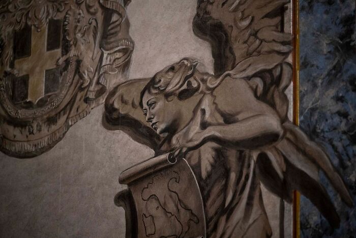 Fresco detail showing an angel holding a scroll inside a restored church in Rome Diocese ordered by Pope.