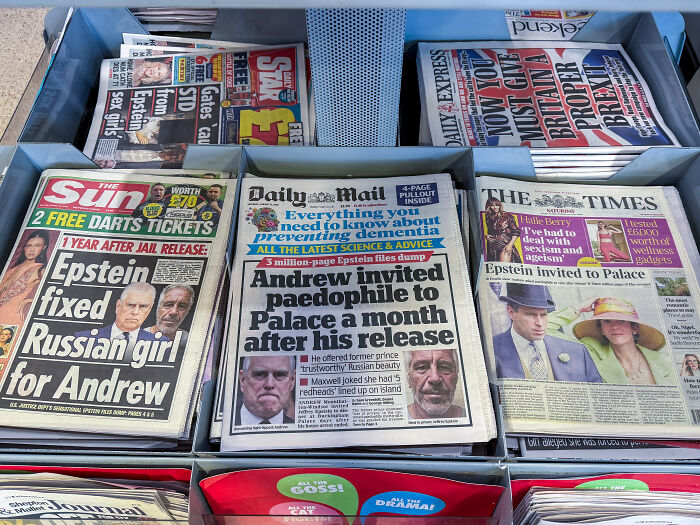 Newspapers with headlines related to Jeffrey Epstein and efforts to resuscitate him after being found in his cell.