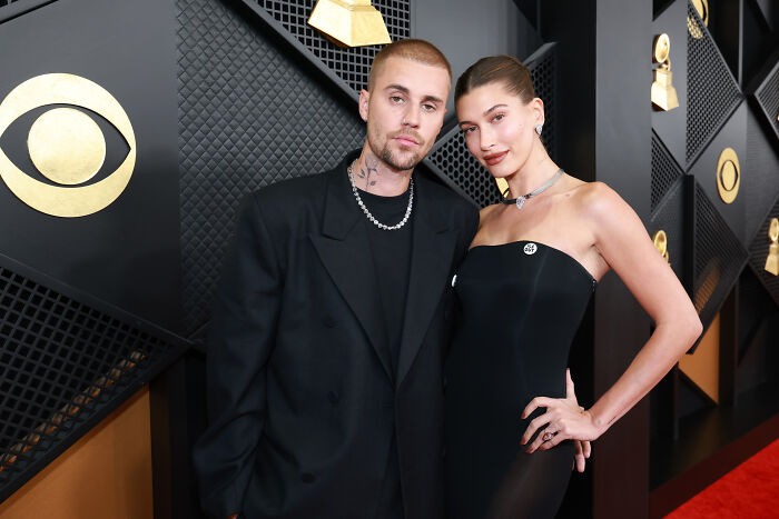 Justin Bieber and Hailey Bieber posing on the red carpet at the Grammys where stars spoke out against ICE.