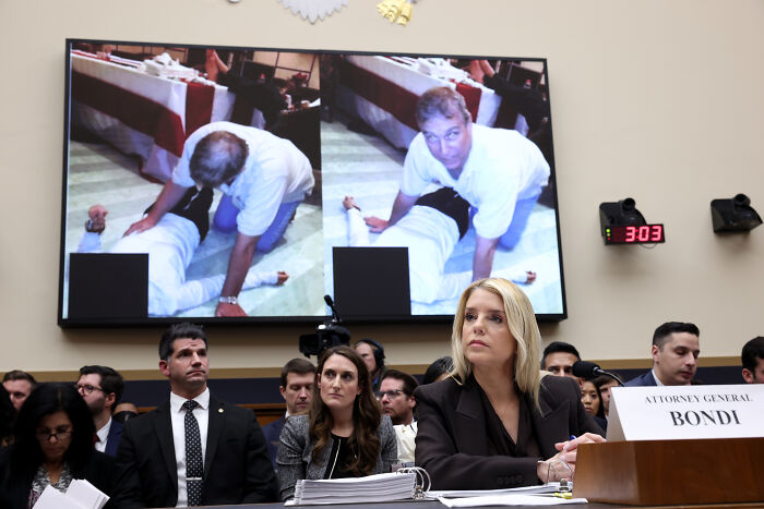 Attorney General Bondi testifying during a House Democrats hearing with images of a confrontation displayed behind.