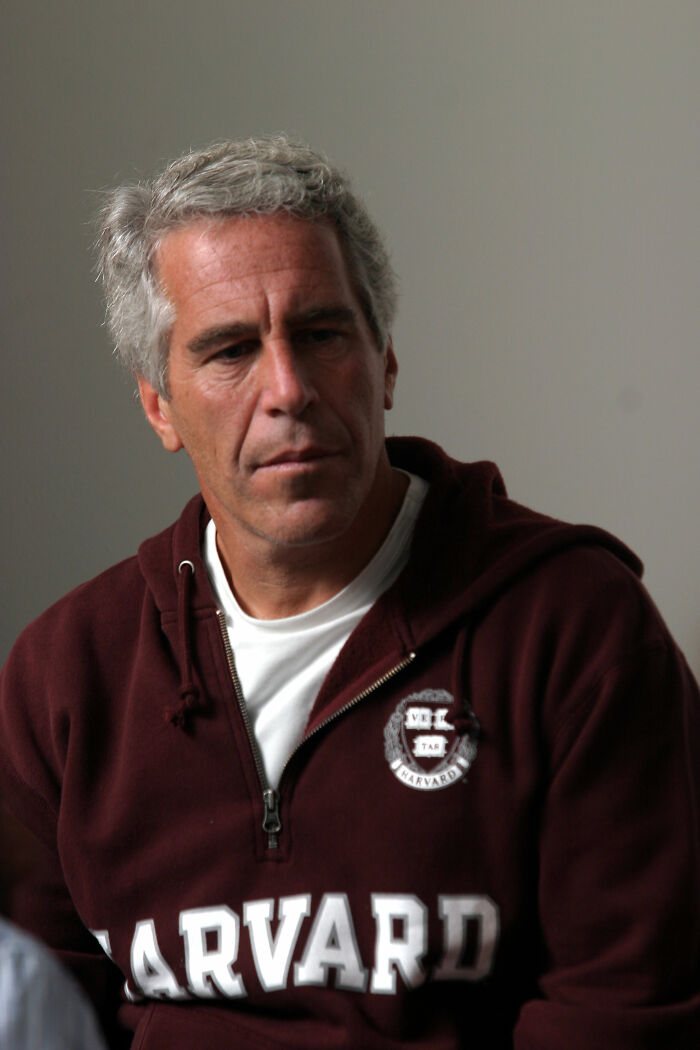 Man in a maroon Harvard sweatshirt sitting indoors, related to Bill Gates details emerging after Epstein allegations.