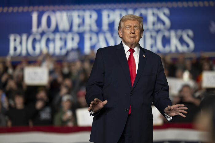Former President Trump at a rally, addressing supporters amid controversy over Trevor Noah Epstein joke lawsuit threats.