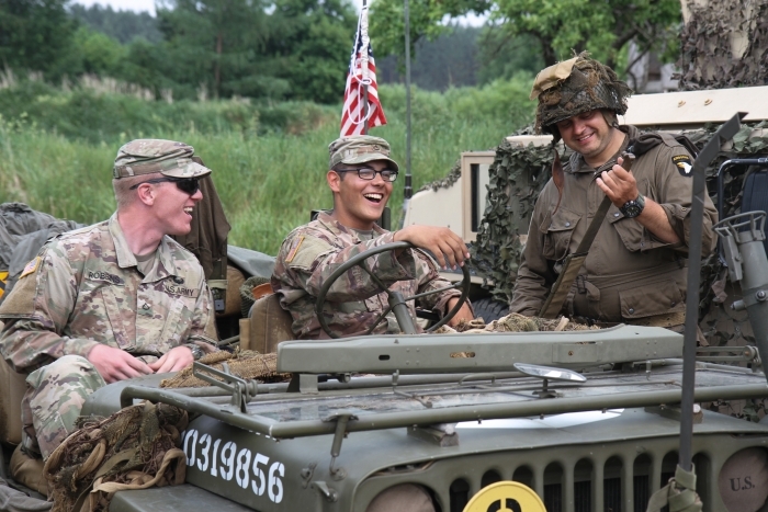 Two cavalry scouts with 2nd Battalion, 8th Cavalry Regiment, 1st Army Brigade Combat Team, exchange banter with a local resident at Children’s Appreciation Day June 2, 2018 in Konotop, Poland. (Michigan Army National Guard photo by Sgt. Ashley Terpsma/Released). Two cavalry scouts with 2nd Battalion, 8th Cavalry Regiment, 1st Army Brigade Combat Team, exchange banter with a local resident at Children’s Appreciation Day June 2, 2018 in Konotop, Poland. (Michigan Army National Guard photo by Sgt. Ashley Terpsma/Released).